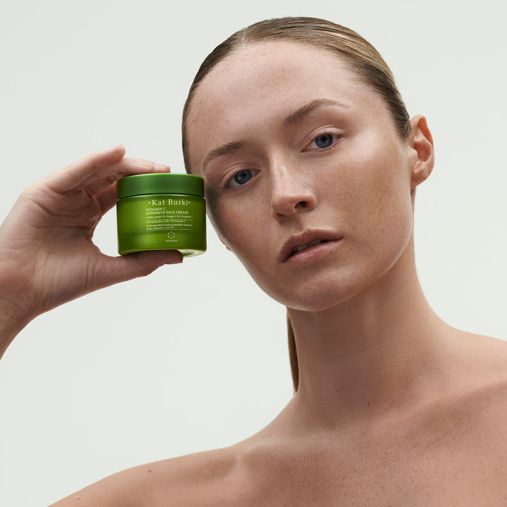 a woman holding a green jar